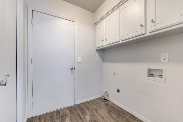 washroom featuring dark wood-type flooring, baseboards, washer hookup, cabinet space, and electric dryer hookup