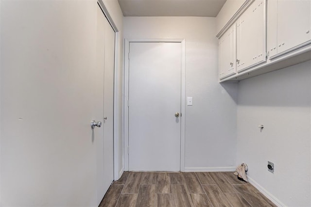 laundry area featuring cabinet space, hookup for an electric dryer, baseboards, and wood tiled floor