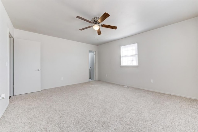 carpeted empty room with a ceiling fan