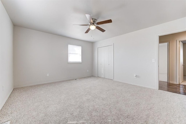 unfurnished bedroom with a closet, ceiling fan, baseboards, and carpet