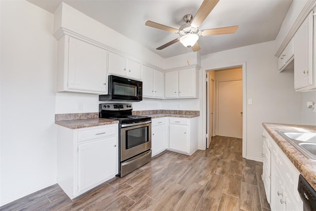 kitchen with stainless steel electric range oven, light wood-style floors, black microwave, and dishwashing machine