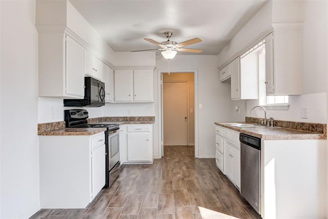 kitchen with light wood finished floors, ceiling fan, white cabinets, stainless steel appliances, and a sink