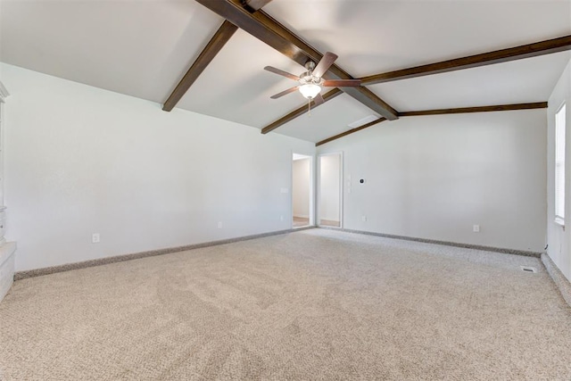 carpeted empty room with lofted ceiling with beams, visible vents, baseboards, and ceiling fan