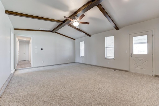 unfurnished living room with lofted ceiling with beams, baseboards, light carpet, and a ceiling fan