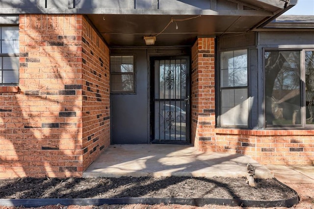 entrance to property with brick siding