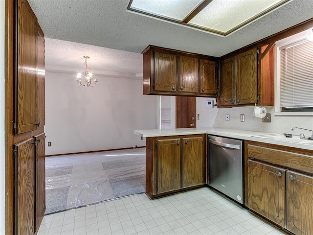 kitchen featuring dishwasher, a textured ceiling, light countertops, and a peninsula