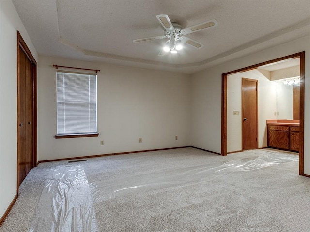 unfurnished bedroom with visible vents, light carpet, a closet, baseboards, and ceiling fan