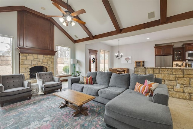 living area featuring visible vents, high vaulted ceiling, beam ceiling, light tile patterned flooring, and a stone fireplace