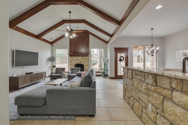 living area with ceiling fan with notable chandelier, beam ceiling, light tile patterned floors, and a fireplace