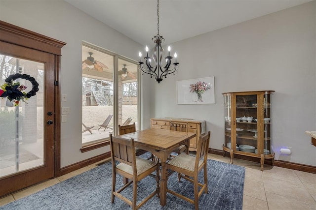 dining space featuring light tile patterned flooring, a healthy amount of sunlight, and baseboards