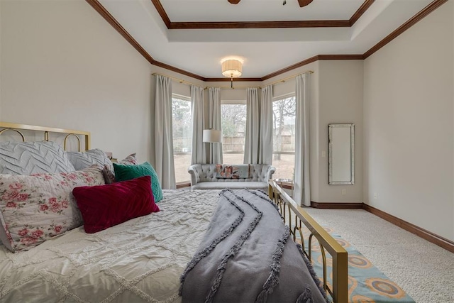 bedroom featuring multiple windows, a raised ceiling, and crown molding