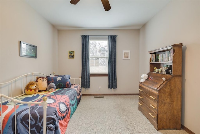 carpeted bedroom with visible vents, baseboards, and ceiling fan