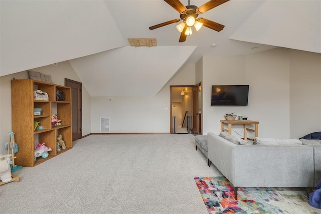 living area featuring lofted ceiling, baseboards, visible vents, and light carpet