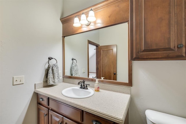 bathroom with toilet and vanity