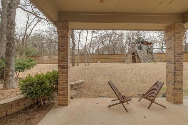 view of patio with a fenced backyard and a playground