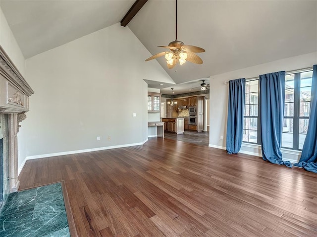 unfurnished living room with beam ceiling, a fireplace with flush hearth, dark wood-type flooring, and a ceiling fan