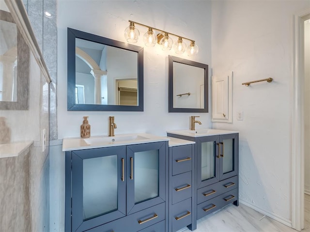 full bathroom with a sink, marble finish floor, and two vanities