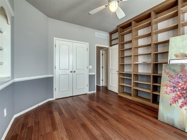 unfurnished bedroom with visible vents, baseboards, a closet, and wood finished floors