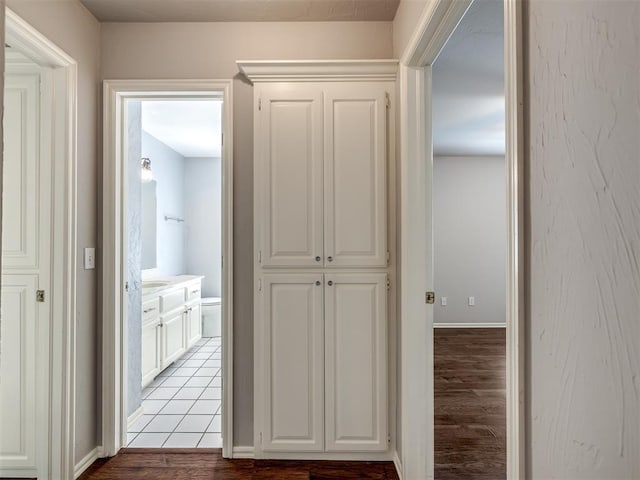 hall featuring baseboards and light wood finished floors