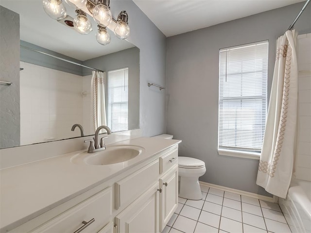 full bathroom with a wealth of natural light, tile patterned flooring, toilet, and vanity