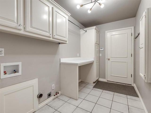 washroom with light tile patterned floors, cabinet space, electric dryer hookup, washer hookup, and a chandelier