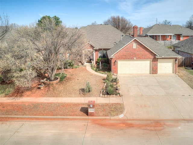 view of front of property featuring driveway, a shingled roof, a garage, brick siding, and a chimney