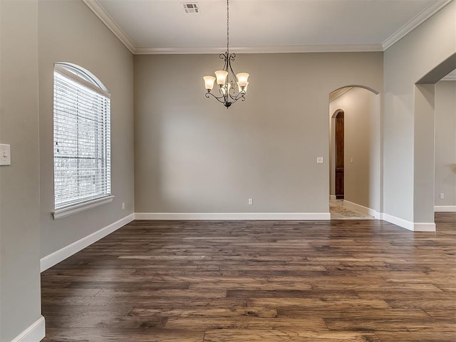 empty room featuring baseboards, arched walkways, dark wood-style flooring, and crown molding