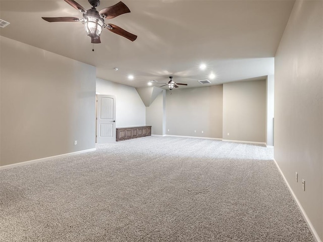 interior space with carpet flooring, visible vents, baseboards, and ceiling fan