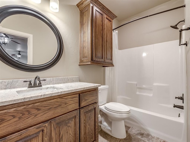 bathroom featuring bathing tub / shower combination, toilet, vanity, and ceiling fan