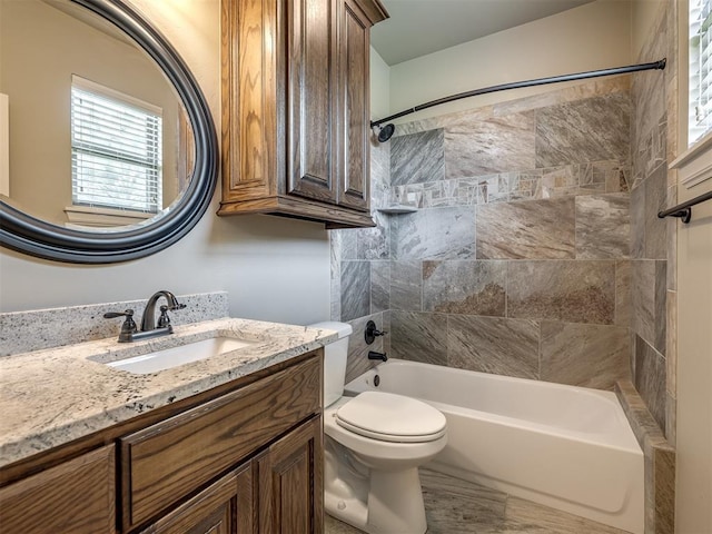 full bathroom with toilet, vanity, and shower / tub combination