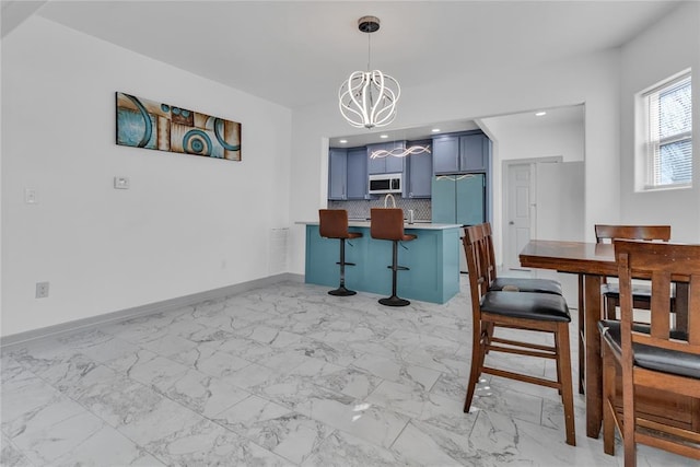 1612 N Klein Ave, Oklahoma City, OK 73106 - dining room with a chandelier, marble finish floor, and baseboards