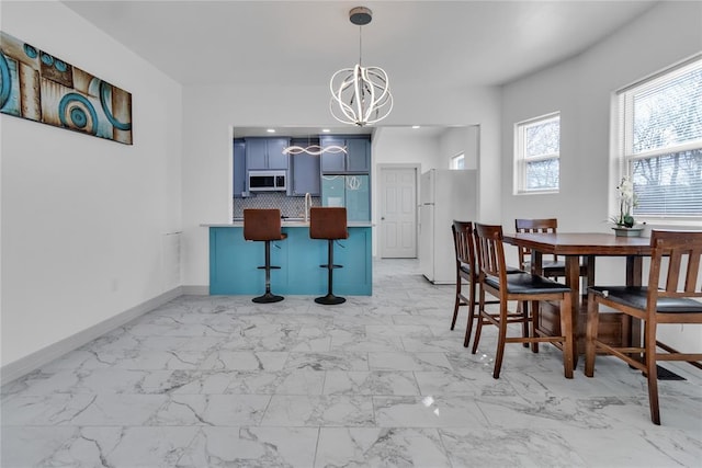 1612 N Klein Ave, Oklahoma City, OK 73106 - dining area featuring baseboards, a notable chandelier, and marble finish floor