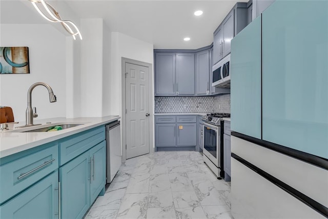 1612 N Klein Ave, Oklahoma City, OK 73106 - kitchen with a sink, stainless steel appliances, light countertops, marble finish floor, and backsplash