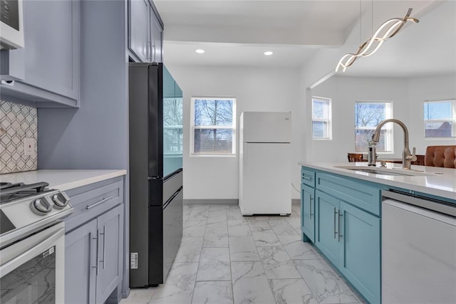 1612 N Klein Ave, Oklahoma City, OK 73106 - kitchen with dishwashing machine, marble finish floor, freestanding refrigerator, and a sink