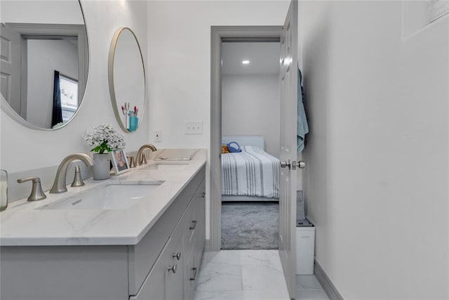 1612 N Klein Ave, Oklahoma City, OK 73106 - ensuite bathroom with double vanity, marble finish floor, baseboards, and a sink