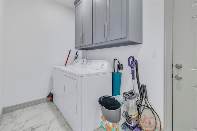 1612 N Klein Ave, Oklahoma City, OK 73106 - washroom with baseboards, cabinet space, marble finish floor, and washing machine and clothes dryer