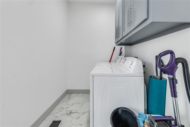 1612 N Klein Ave, Oklahoma City, OK 73106 - clothes washing area with visible vents, independent washer and dryer, marble finish floor, cabinet space, and baseboards