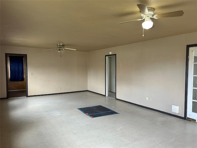 unfurnished room with tile patterned floors, baseboards, and ceiling fan