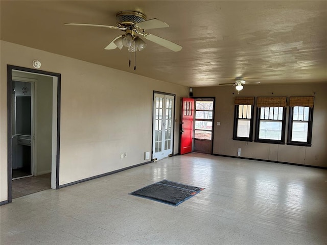 unfurnished room featuring baseboards and a ceiling fan