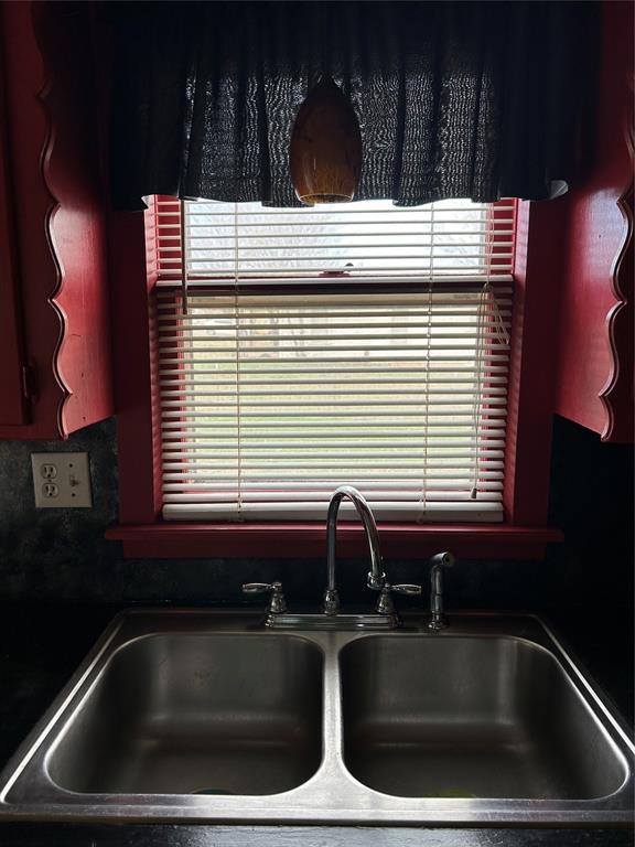 interior space with a sink and dark countertops