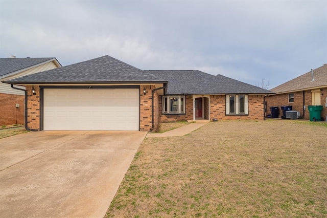 ranch-style home with brick siding, concrete driveway, a front yard, and roof with shingles