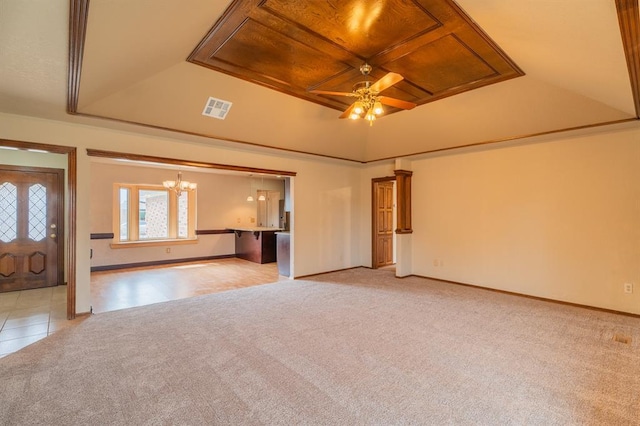 unfurnished living room with visible vents, baseboards, light colored carpet, a tray ceiling, and ceiling fan with notable chandelier