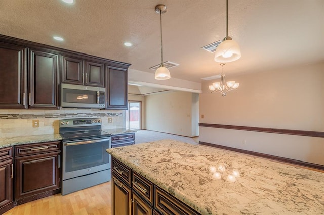 kitchen featuring a notable chandelier, tasteful backsplash, visible vents, and stainless steel appliances