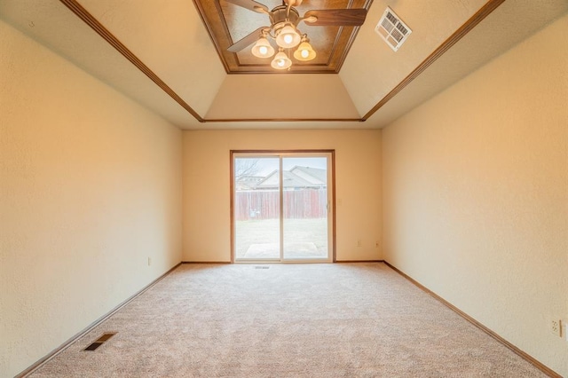 empty room featuring visible vents, a raised ceiling, carpet floors, and ceiling fan