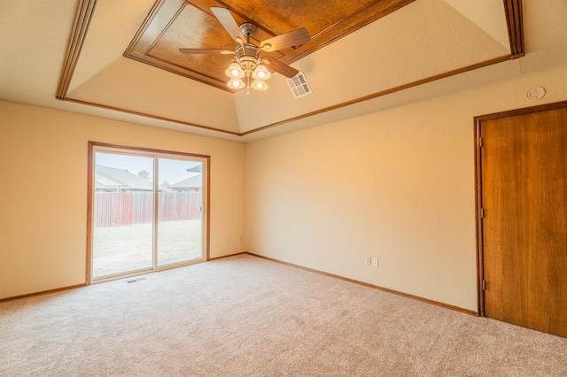 spare room with visible vents, a ceiling fan, baseboards, carpet flooring, and a raised ceiling