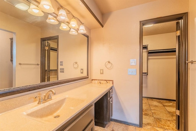 bathroom featuring vanity and baseboards