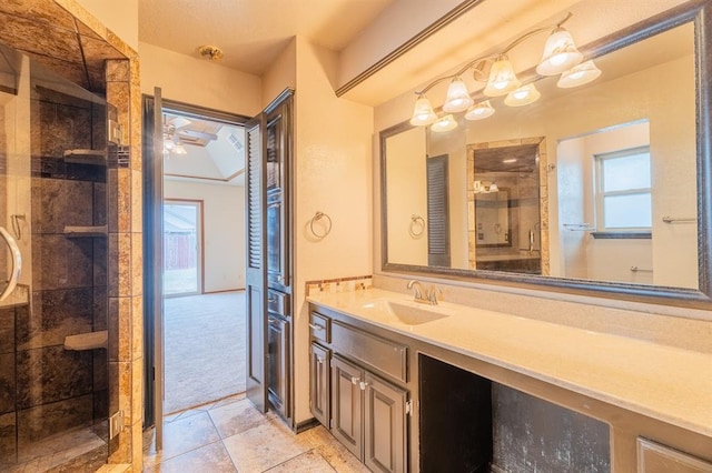 full bathroom with a wealth of natural light, a shower stall, tile patterned floors, and vanity