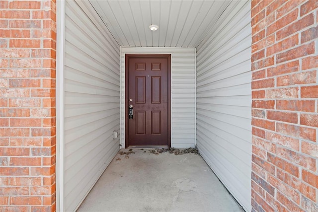 property entrance featuring brick siding