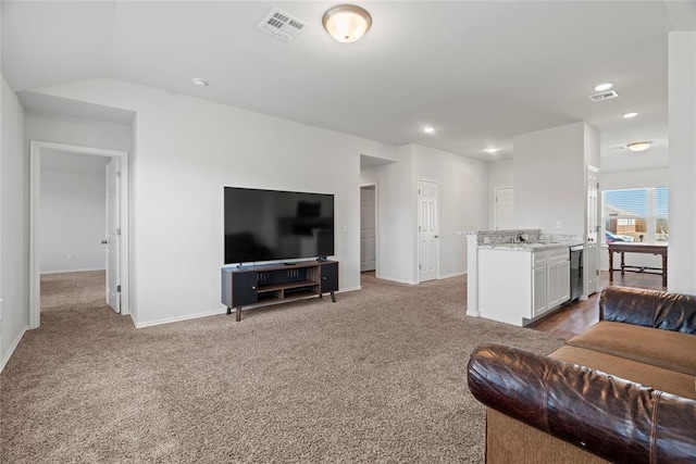 carpeted living room with visible vents, recessed lighting, baseboards, and vaulted ceiling