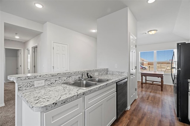 kitchen featuring a peninsula, freestanding refrigerator, a sink, white cabinets, and dishwasher